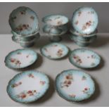 A 'LIMOGES' DESSERT SERVICE with transfer printed floral decoration on a blue border.