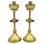 A PAIR OF 19TH CENTURY ECCLESIASTICAL BRASS CANDLESTICKS, gothic style with lattice engraved