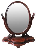 A 19TH CENTURY MAHOGANY TABLE MIRROR, CIRCA 1880, tilting oval plate raised on scrolling supports on