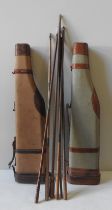 TWO VINTAGE CANVAS AND LEATHER GUN CASES, leg of mutton form, along with six gun cleaning rods the