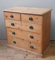 A 19TH CENTURY WAXED PINE CHEST OF DRAWERS, rectangular top with applied mouldings, above two
