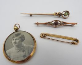 A 9CT GOLD MOUNTED OVAL PENDANT AND TWO 9CT GOLD BAR BROOCHES, along with a yellow metal brooch