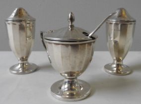 A SILVER THREE PIECE CRUET SET, tapered faceted form, comprised of mustard pot, pepper pot and
