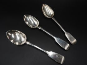 A PAIR OF VICTORIAN SILVER SERVING SPOONS AND ONE OTHER, all fiddle pattern, the pair marked London,