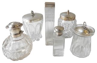 A GROUP OF FIVE SILVER LIDDED GLASS JARS AND A SCENT BOTTLE 16 cm high max Total weight of lids: 132