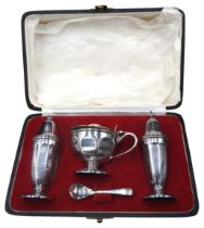 A BOXED SILVER THREE PIECE CRUET SET, comprised of salt shaker, pepper pot and mustard pot with