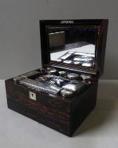 A MID VICTORIAN COROMANDEL DRESSING CASE, CIRCA 1875, the rectangular form case inset with mother of