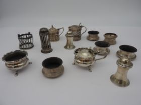 A GROUP OF SILVER BULLION WARES, the lot consisting of cruets and bottle tops, all bearing hall