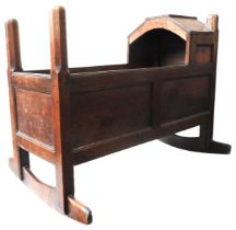 A LATE 17TH/EARLY 18TH CENTURY OAK PANELLED CRADLE, with flat panel arch canopy and chamfered
