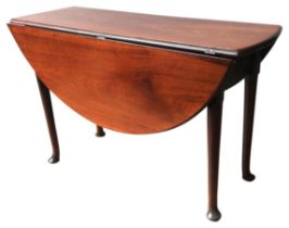 A GEORGE III MAHOGANY DROP-LEAF TABLE, hinged circular top raised on four Queen Anne legs 69 x 106 x