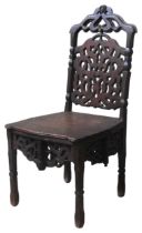 A CONTINENTAL OAK HALL CHAIR, LATE 18TH/EARLY 19TH CENTURY, the arch top rail with carved mask