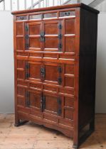 A KOREAN TANSU STORAGE CUPBOARD, simplistic rectangluar form with panelled front, wo short frieze