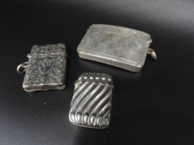 A GROUP OF THREE VICTORIAN SILVER VESTA CASES, the lot comprised of the following: a ribbed vesta,