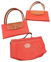 A LONGCHAMP LE PLIAGE RED CANVAS LARGE TOTE BAG WITH SMALLER RED ZIPPABLE TOTE BAG AND RED WASHBAG