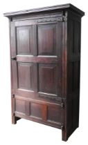 A GEORGE III OAK PANELLED HOUSE CUPBOARD, circa 1780, rustic rectangular form with a panelled door