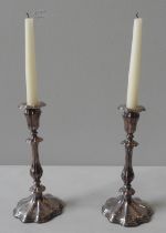 A PAIR OF CONTINENTAL WHITE METAL CANDLESTICKS of fancy lobed form with engraved floral decoration