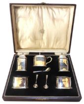 A BOXED FIVE PIECE SILVER CRUET SET, simplistic rectangular form with canted corners and a rope