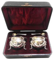 A PAIR OF LATE VICTORIAN SILVER SALTS, in a presentation box, each with a salt spoon,  fluted