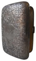A LARGE SILVER CIGARETTE CASE, with profuse chased scroll foliate decoration throughout, and a