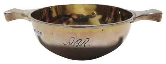 A GEORGE V SILVER GILT QUAICH, simplistic form with engraved monogram, the twin handles engraved