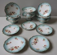 A 'LIMOGES' DESSERT SERVICE with transfer printed floral decoration on a blue border.