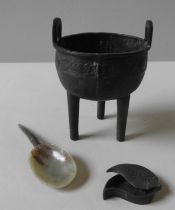 A CHINESE BRONZE TRIPOD CENSER lead soldered and repaired in three sections, a green hardstone spoon