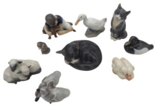 A GROUP OF NINE ROYAL COPENHAGEN PORCELAIN MODELS, the lot comprised of a model of boy with puppy,