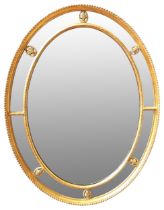 AN OVAL GILT WOOD REGENCY MIRROR, CIRCA 1780, gadrooned edge frame with beaded slip, united by six