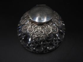 A HEAVY CUT GLASS SILVER MOUNTED INKWELL, domed form with cut glass base, an ornate scrolling