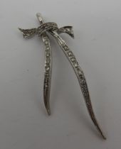 A WHITE METAL MARQUISITE PENDANT, elegantly formed as a tied bow, unmarked  5 cm long