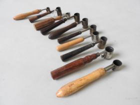 A GROUP OF TEN VINTAGE GUNPOWDER MEASURES, mostly French, some with adjustable cups, all with turned