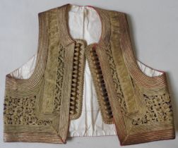 AN OTTOMAN CHILD'S WAISTCOAT, LATE 19TH / EARLY 20TH CENTURY, purple velvet embroidered with metal