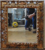 A CARVED GILTWOOD MIRROR, 19TH CENTURY, the ornately carved frame with a rope twist edge and