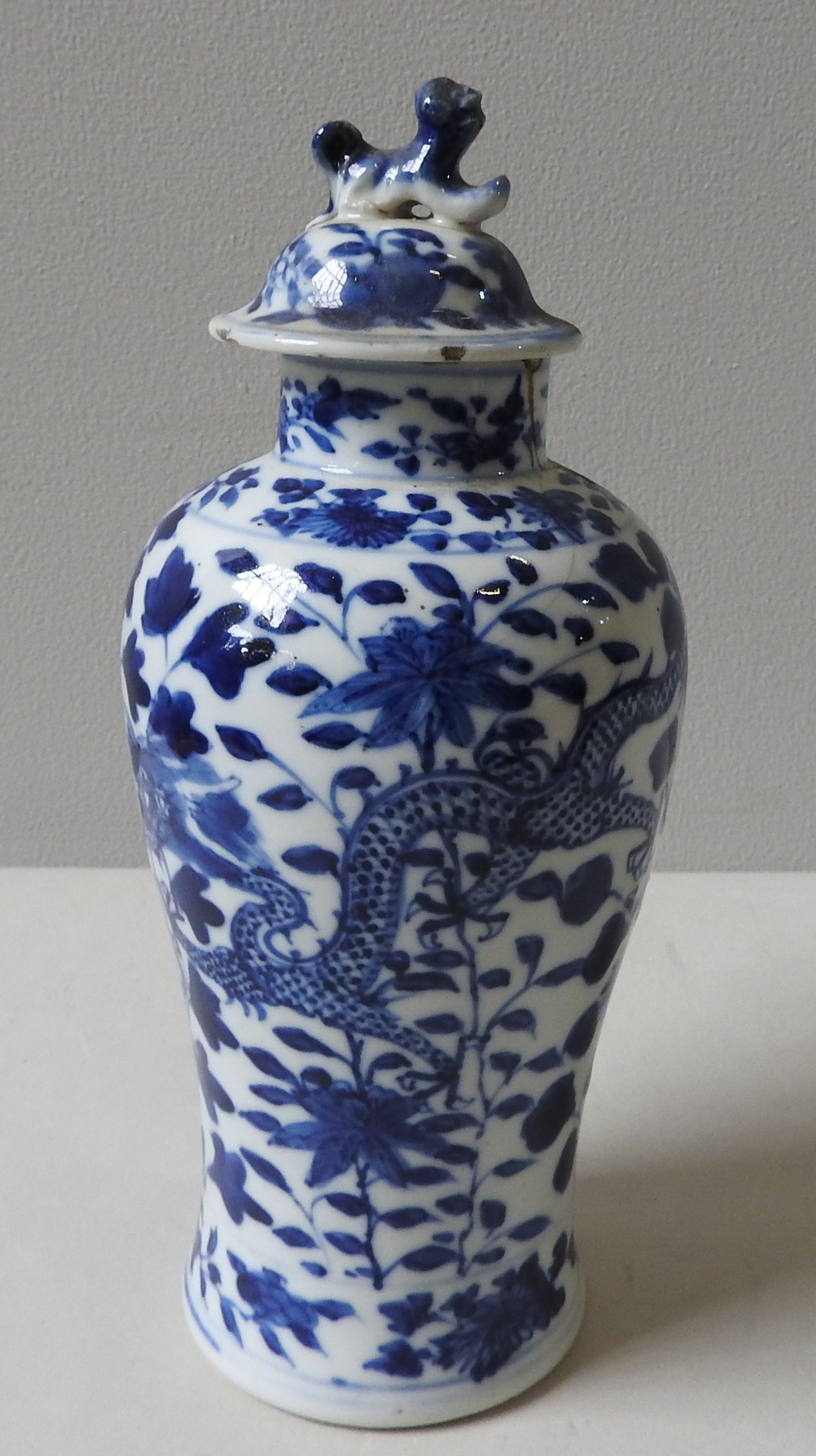 A BLUE AND WHITE CHINESE BALUSTER VASE AND COVER, QING DYNASTY, the cover surmounted by a temple