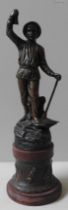 A CAST SPELTER FIGURE OF A MINER, EARLY 20TH CENTURY, modelled holding a lamp aloft with a pick