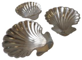 A PAIR OF EDWARDIAN SILVER BUTTER DISHES AND A SINGLE BUTTER DISH, all of shell form and raised on