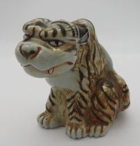 A JAPANESE PORCELAIN MODEL OF TIGER, MEIJI PERIOD, stylistically modelled in seated pose 13 cm high