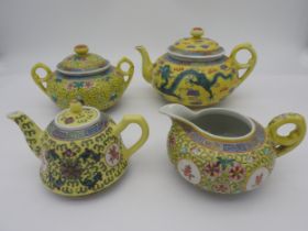 A CHINESE YELLOW GROUND IMPERIAL STYLE TEAPOT decorated with green five claw dragons together with