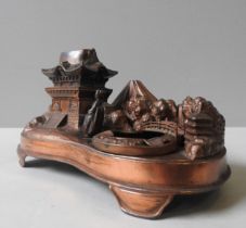 A VINTAGE NOVELTY MUSICAL INKSTAND, MID 20TH CENTURY, kidney form base, the inkwell modelled as a