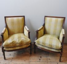 A PAIR OF FRENCH EMPIRE STYLE ARMCHAIRS, 20TH CENTURY, the foliate carved frames covered in a pale