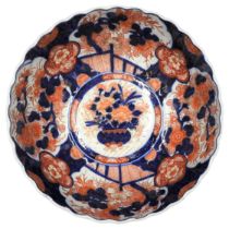 A JAPANESE IMARI BOWL, circular scalloped edge form, decorated in the typical palette, the