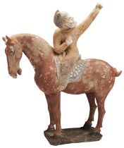 A CHINESE POTTERY LARGE UNGLAZED MODEL OF AN EQUESTRIAN ARCHER TANG DYNASTY, 618-907 with his left