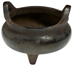 A SMALL CHINESE BRONZE TRIPOD CENSER 19TH / 20TH CENTURY Of compressed form with out swept pierced