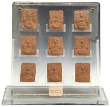 A SET OF NINE POTTERY TABLETS TANG DYNASTY (618-907) the miniature tables each moulded with a Buddha