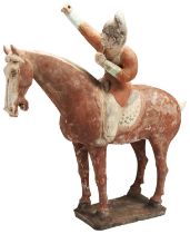 A CHINESE POTTERY LARGE UNGLAZED MODEL OF AN EQUESTRIAN ARCHER TANG DYNASTY (618-917) with his right