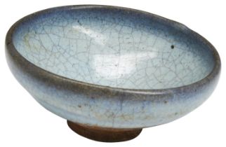 A JUN WARE BOWL YUAN DYNASTY (1279-1368) covered in a pale blue crackle suffused glaze with lavender