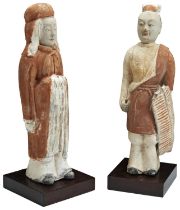 TWO CHINESE STANDING UNGLAZED POTTERY FIGURES TANG DYNASTY (618-917) one of a warrior with an open