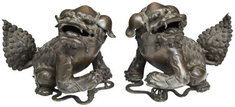 A LARGE PAIR OF BRONZE BUDDHIST LIONS MING DYNASTY (1368-1644) the male and female lions cast with