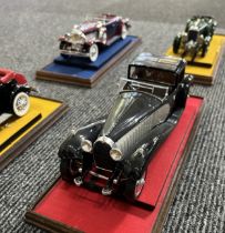 EIGHT PRE-WAR MODEL CARS IN GLASS CASES (1:24) Acquired by our client new in the 1970s, mounted on