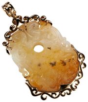 CARVED WHITE AND RUSSET JADE PENDANT in the archaistic style within an ornate rococo yellow gold